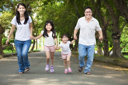 happy asian family walking on the roadの写真素材