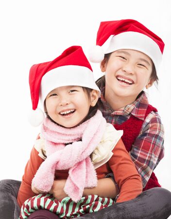 Happy girls in christmas hat and sitting togetherの写真素材