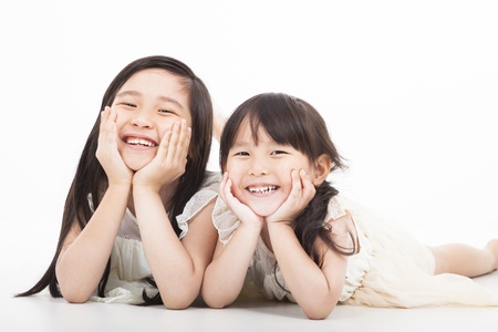 happy two asian girls  on the white backgroundの写真素材
