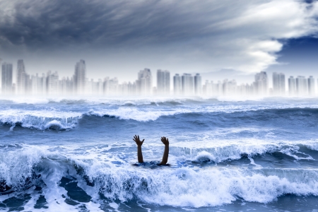 global warming and extreme weather concept. man drowning in the water and storm destroyed the cityの写真素材