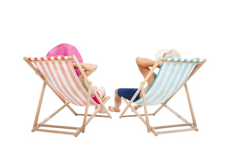 happy Couple sitting on  beach chairs isolated on whiteの写真素材