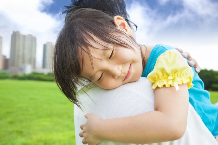 smiling little girl sleeping on his father shoulderの写真素材