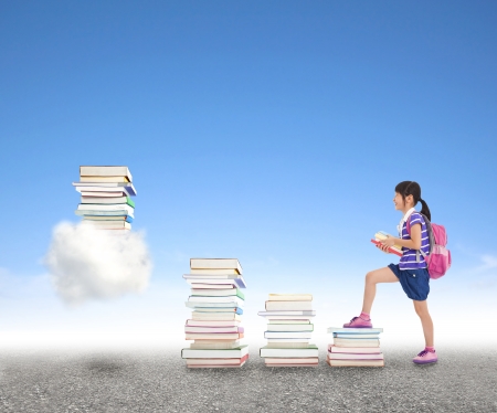 school girl learning knowledge from books to the cloud computing application conceptの写真素材