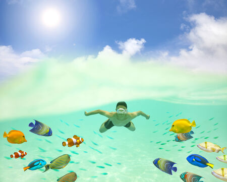 happy young man swimming undersea with colorful fishes and bubbleの写真素材