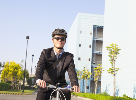 businessman riding a bicycle to workplace for protecting environmentの写真素材