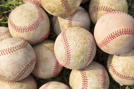 Pile up a stack of old baseball in greenの写真素材