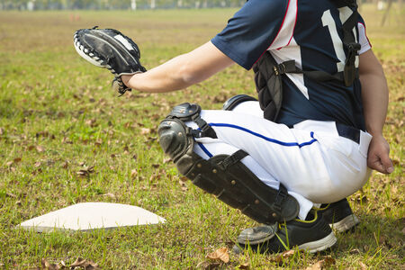 baseball catcher ready to catch ball at  home plateの写真素材