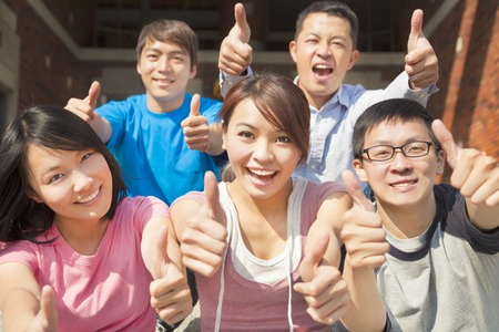 Group of happy students with thumbs up
