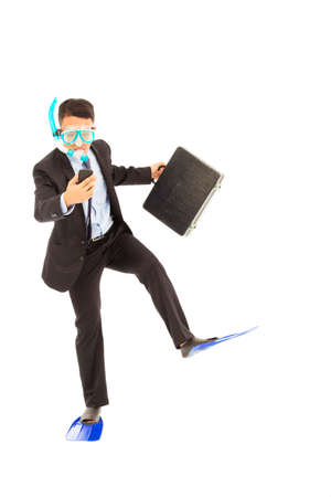 funny businessman standing in studio and watching cell phoneの写真素材