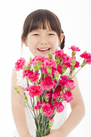 close up of happy little girl holding  a bouquet of carnationsの写真素材