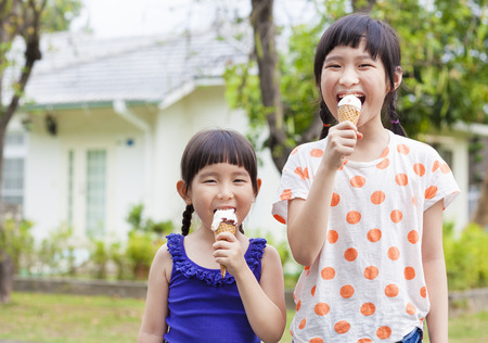 Cute little Girls  Eating Ice Creamの写真素材