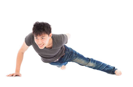 confident young man make push-ups by single handの写真素材