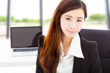 young confident businesswoman sitting in her officeの写真素材