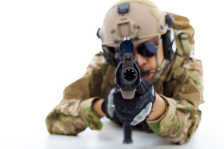 Soldier with rifle against and lying on floor isolated on white 
