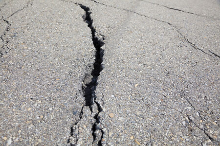 Cracked road on asphalt close upの写真素材