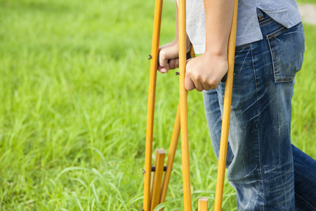 closeup of leg on bandage with crutchesの写真素材