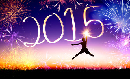 happy new year 2015 . young man jumping and drawing 2015 by flashlightの写真素材