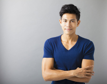 smiling muscular asian young manの写真素材