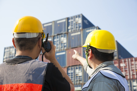 containers workers discussion and pointing for inspection