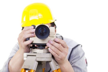 Surveyor worker making measurement  and isolated on whiteの写真素材