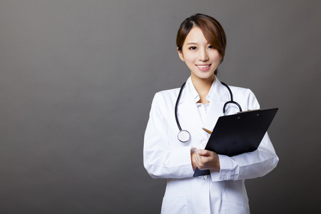 smiling female doctor with clipboardの写真素材