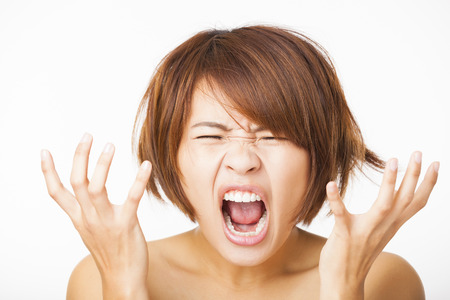 Closeup stressed young woman and yelling screamingの写真素材