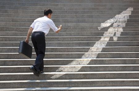 Businessman with stair in business graph concept