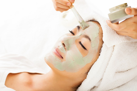 Young beautiful woman with clay facial maskの写真素材