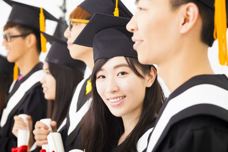 beautiful asian female college graduate at graduation with classmatesの写真素材