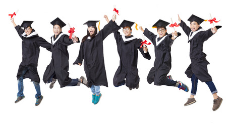 Happy  student group in graduate robe jumping togetherの写真素材