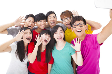 group of smiling friends with camera  taking self photoの写真素材