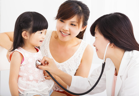 happy Little girl and young  in hospital having examinationの写真素材