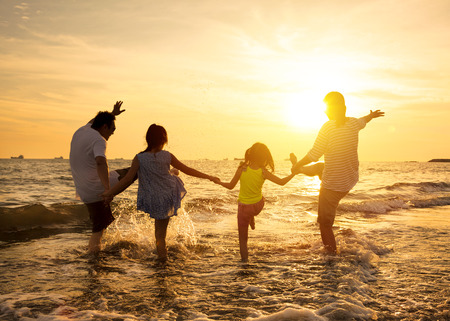 happy family enjoy summer vacation on the beachの写真素材