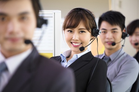 young business people working with headset in officeの写真素材