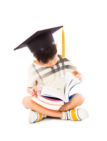 little boy sitting and reading a book