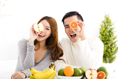 happy Young couple eating fruit and healthy foodの写真素材