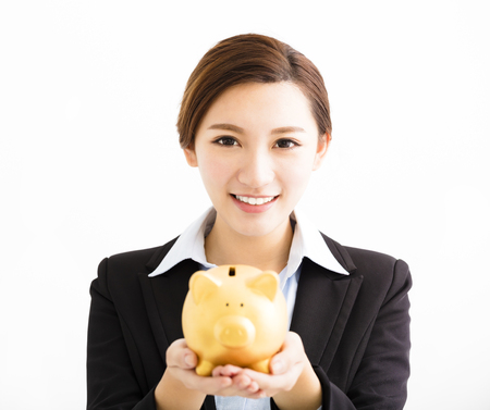smiling business Woman showing the  piggy bankの写真素材