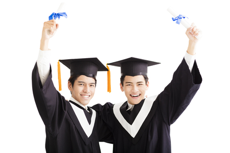 Two happy graduating students isolated on whiteの写真素材