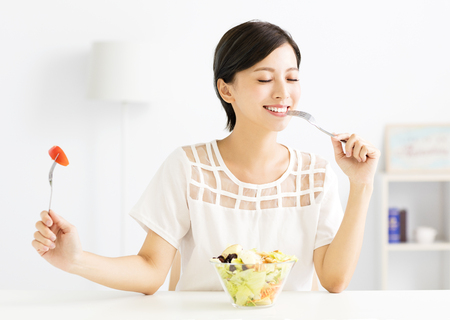 beautiful  young woman eating healthy foodの写真素材