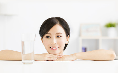 Attractive young woman with glass of waterの写真素材