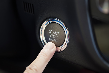 finger pressing the Engine start stop button
