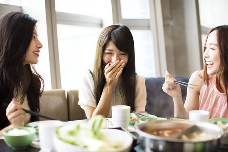 happy young Women group  Eating hot potの写真素材