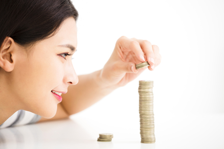 young woman put coins to stack , Saving money concept
の写真素材