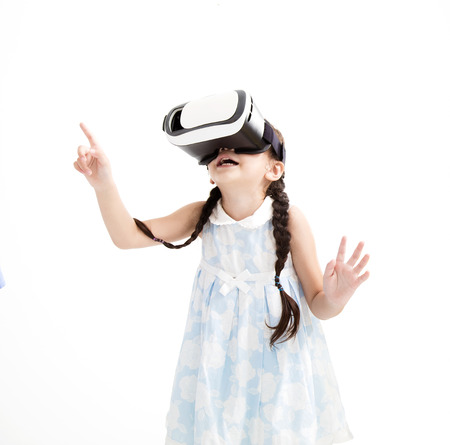 Amazed little girl looking in  VR goggles 