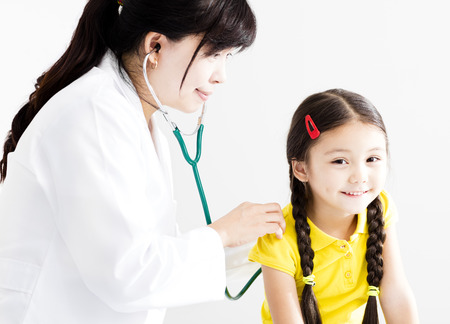 Female Doctor examining  little girl by stethoscopeの写真素材