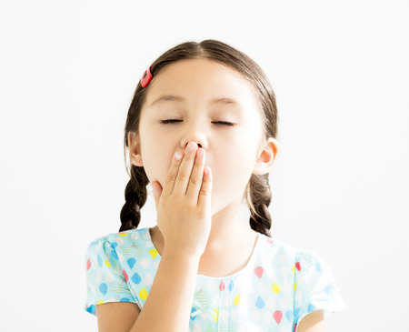 Little girl Yawning Isolated on the White Backgroundの写真素材
