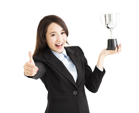 happy Businesswoman showing trophy and thumb upの写真素材
