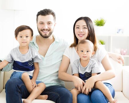 happy mixed race family in living room