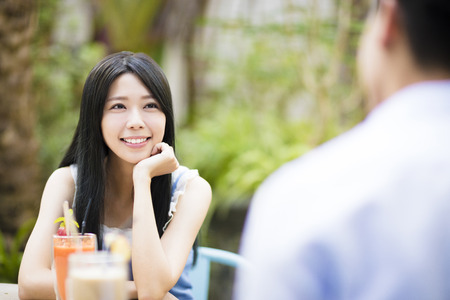 Happy young couple in restaurantの写真素材