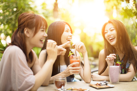 Group of young woman laughing in restaurantの写真素材